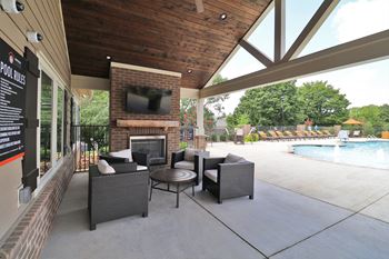 Outdoor pavilion with fireplace, flat screen tv, and food area